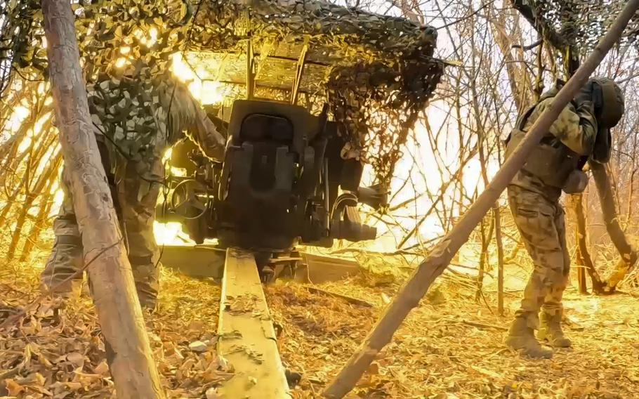 A still frame from a video shows Russian soldiers operating a D-20 howitzer.