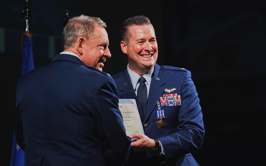 An airman receives an award.