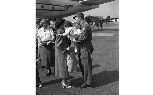 HED: Welcome to Germany, 1950

Frankfurt, Germany, Aug. 10, 1950: After disembarking from the plane, an airmen gives his wife some relief by taking their daughter. U.S. European Command (EUCOM) personnel and their families debark from the Pan American clipper ship called "Morning Star." The plane brought a record passenger load from New York City to Rhein-Main Airport. One-third of the 93 on board were children under the age of 11. 

Looking for Stars and Stripes’ historic coverage? Subscribe to Stars and Stripes’ historic newspaper archive! We have digitized our 1948-1999 European and Pacific editions, as well as several of our WWII editions and made them available online through https://starsandstripes.newspaperarchive.com/

META TAGS: Army; military family; air base; dependents; cilivians; children; family; way of life;