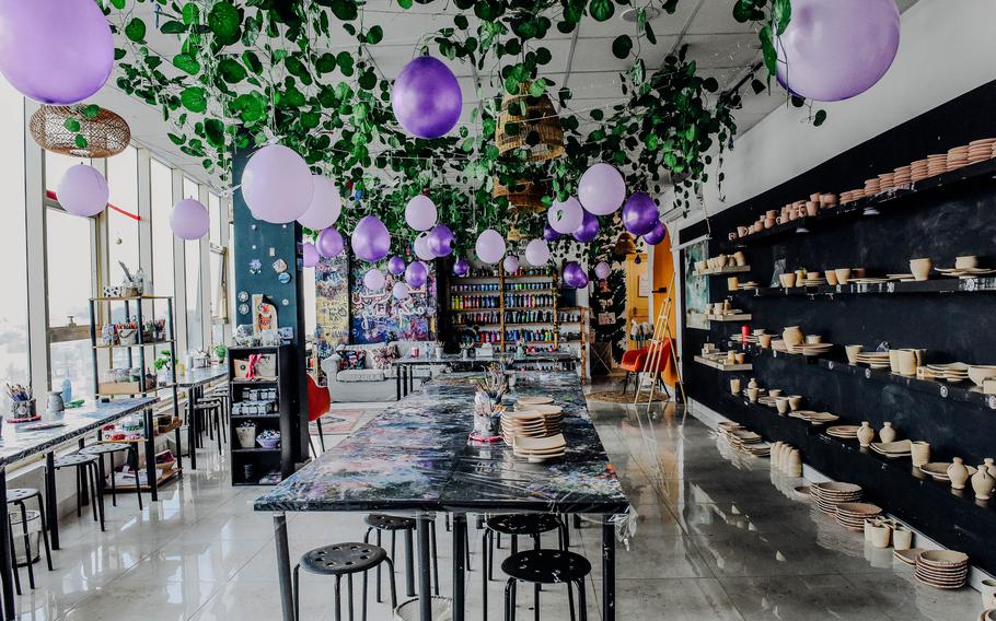 A whimsical creativity space at Passion Art Cafe in Budaiya, Bahrain, welcomes customers with cascading vines, fairy lights and purple balloons on Jan. 7, 2025.