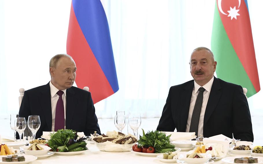 Russian President Vladimir Putin, left, and Azerbaijani President Ilham Aliyev attend a state reception at the Gulustan Palace in Baku, Azerbaijan, Monday, Aug. 19, 2024.