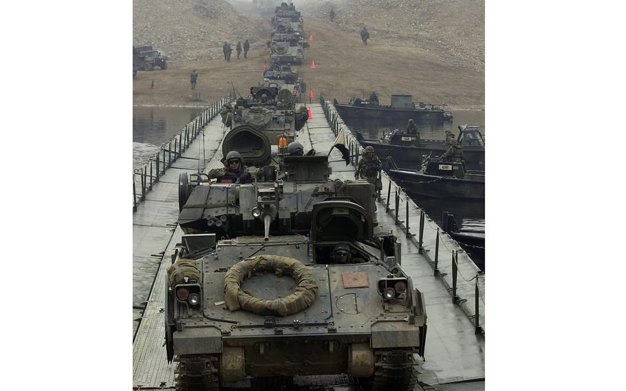 Military vehicles cross the Imjin River