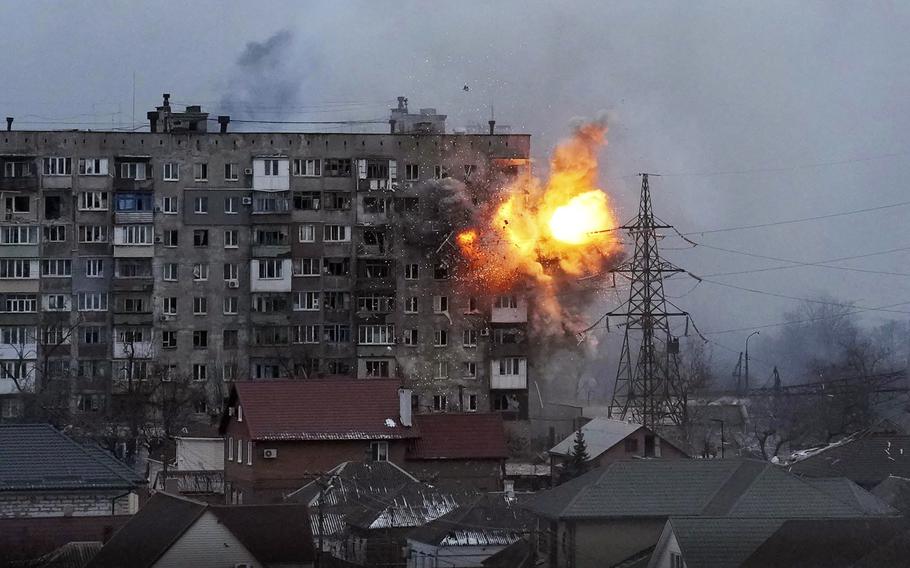 An explosion blasts through the side of an apartment building.