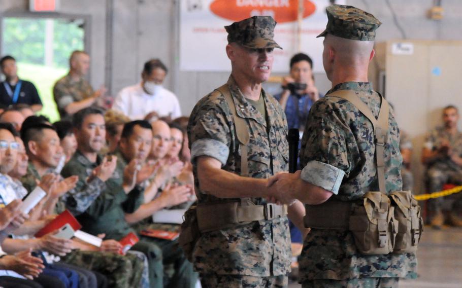 Maj. Gen. Brian Wolford, left, takes command of Marine Corps Installations Pacific from Maj. Gen. Stephen Liszewski, right, at Marine Corps Air Station Futenma, Okinawa, on June 14, 2024.