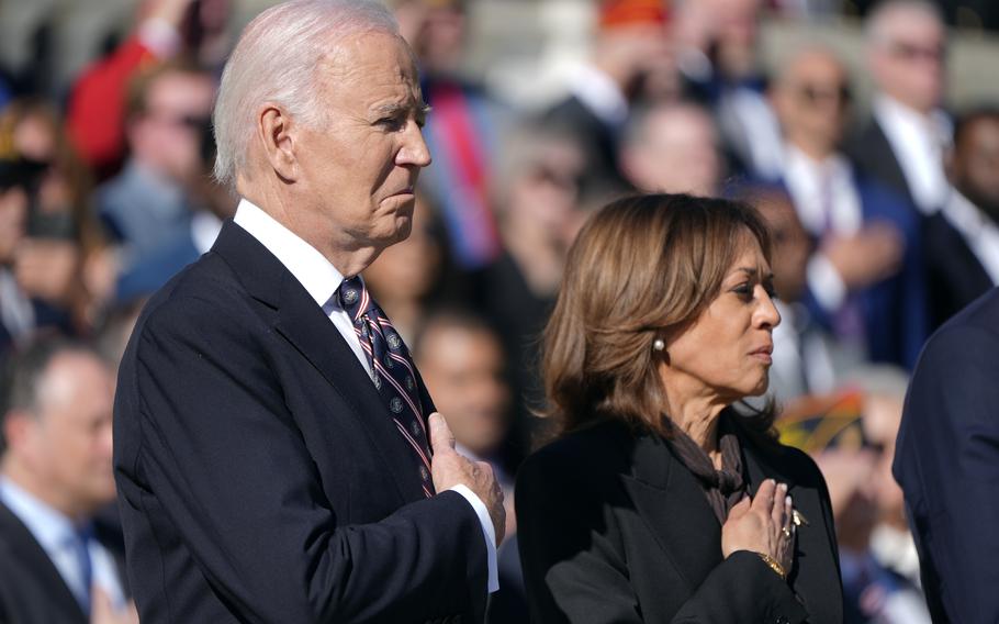 President Joe Biden, left, and Vice President Kamala Harris look on during a wreath laying ceremony