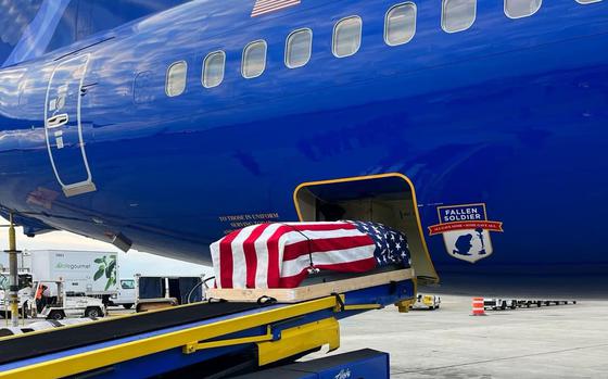 A flag-draped casket holding the remains of Army Pfc. Charles McAllister is unloaded from an Alaska Airlines honor flight at Seattle-Tacoma International Airport, Aug. 15, 2024.