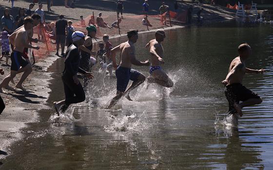 Soldiers and family members of 1st Special Forces Group (Airborne) compete in a 500m swim in American Lake, Joint Base Lewis-McChord as part of 1SFG's (A) Organizational Day held June 22nd.