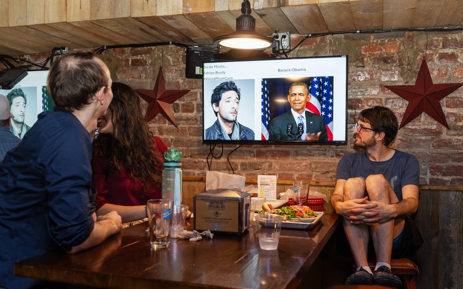 Friends watch a “PowerPoint party” presentation by host Philip Mayer at the Tight Five Pub in Adams Morgan earlier this month.  Mayer, a transportation researcher and former teacher, began hosting the Washington event in May (though the venue has changed to Johnny Pistola’s on the first Wednesday of every month after Tight Five Pub abruptly shuttered its doors).