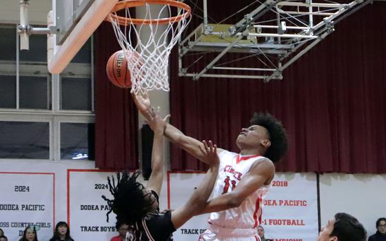 Kinnick's Isaiah Kimbrough drives for a shot against Zama's Casey Stewart.