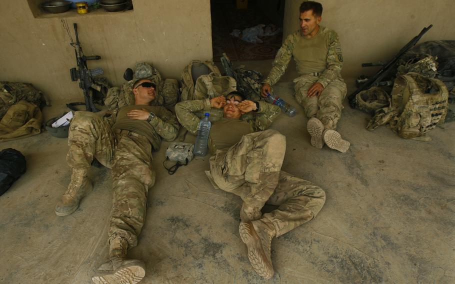 Pfc. Nicholas Seay, left, Pfc Christopher Merendino, and Sgt. 1st Class Carter Conrad all of Company C, 1st Battalion, 32 Infantry Regiment, 3rd Brigade Combat Team, 10th Mountain Division, relax during rest rotation at a compound during Operation Steel Lion III.