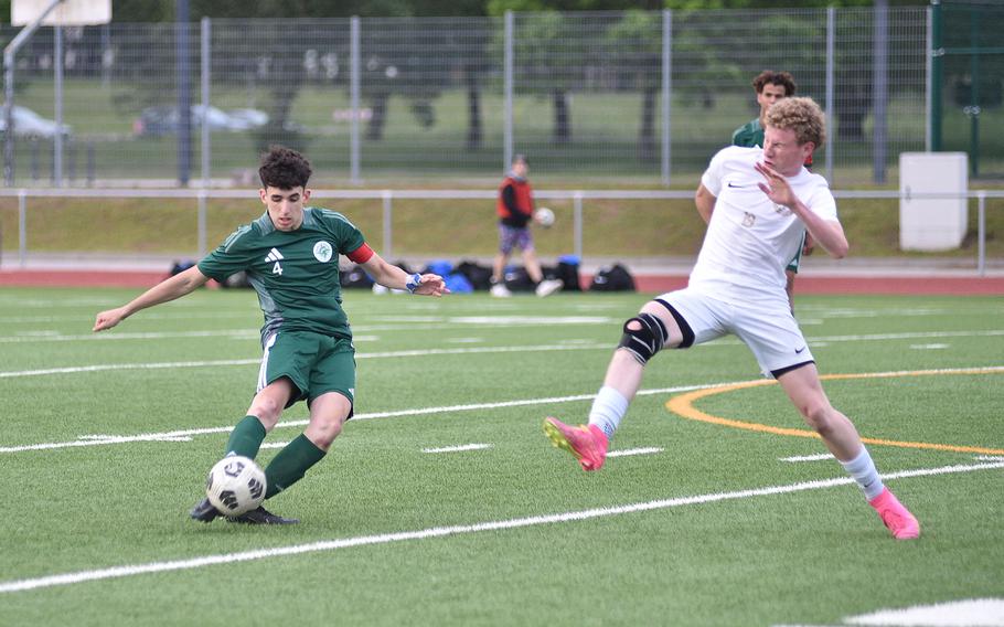 SHAPE center back Jose Labella goes to kick the ball long while Ramstein striker Joseph Yost sticks out a leg to block the pass during the Division I final of the DODEA European championships on May 23, 2024, at Ramstein High School on Ramstein Air Base, Germany.