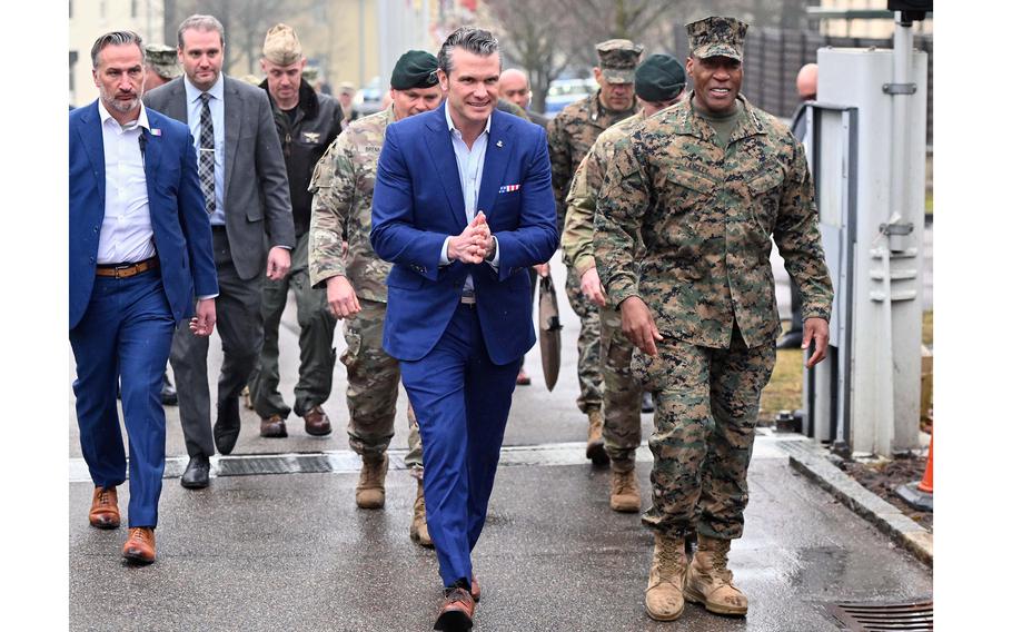 Pete Hegseth walks with Army leaders outside.