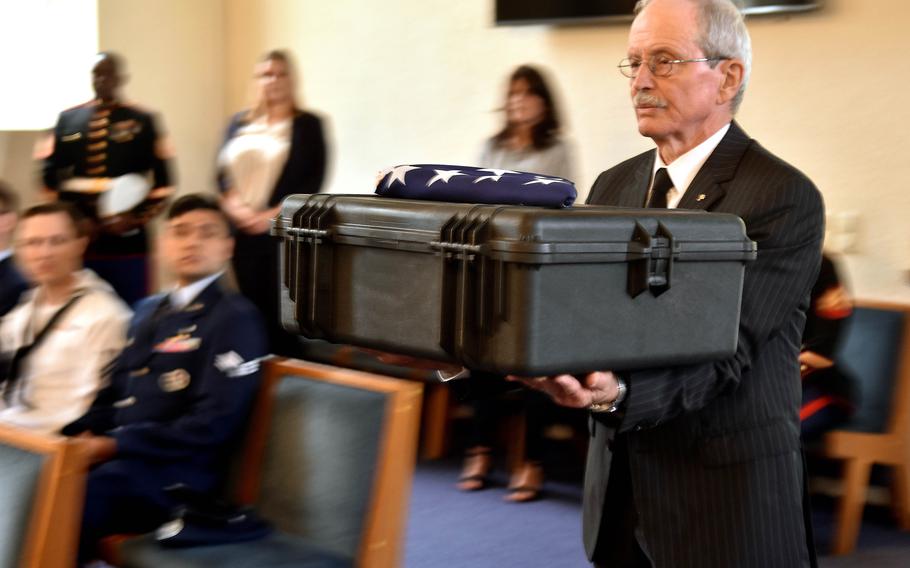 Manfred Hofmeyer carries a box 