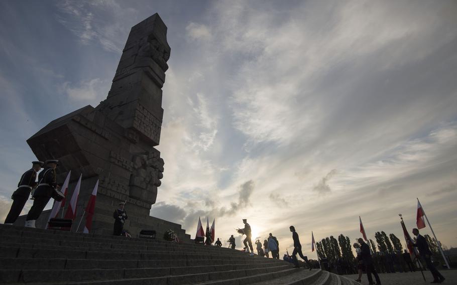 People lay a wreath at the monument to the 1939 heroic defense of the Westerplatte peninsula outpost during solemn observances of the 85th anniversary of the outbreak of World War II, at Westerplatte, on the Baltic Sea, Poland, on Sunday, Sept. 1, 2024. 