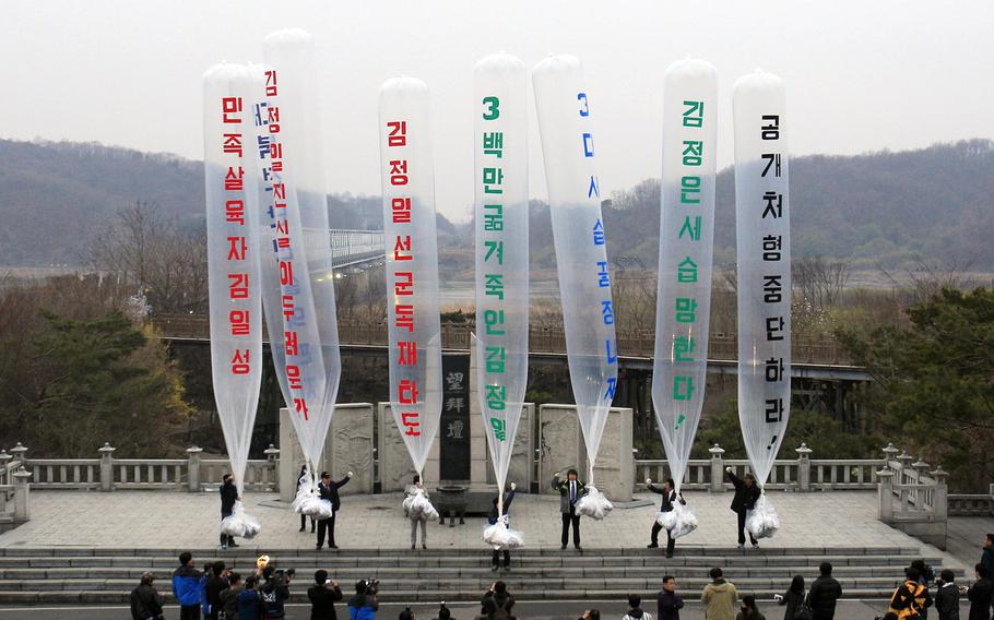 South Korean conservative activists prepare to release balloons bearing leaflets condemning the North Korean leader during an anti-North Korea rally near the border village of Panmunjom in Paju, South Korea, on April 15, 2011. North Korea on Wednesday, Nov. 8, 2023 criticized rival South Korea for removing a law that banned private activists from sending anti-Pyongyang propaganda leaflets to the North, insisting that such activities amount to psychological warfare and threatening to respond with a “shower of shells.”
