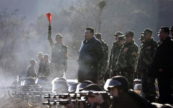 North Korean leader Kim Jong Un watches troops fire their rifles at an undisclosed military base, March 6, 2024. 