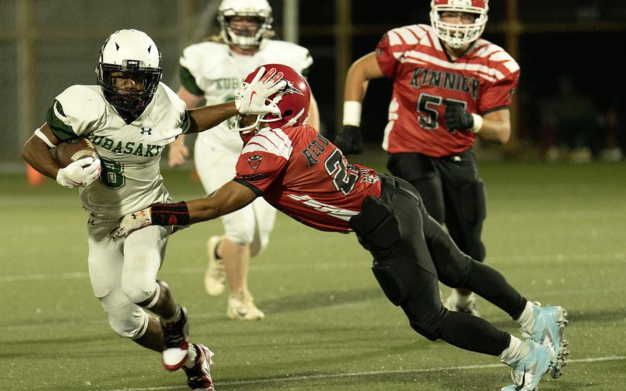 Kubasaki’s Haustyn Lunsford, avoiding a tackle by Kinnick’s Donovan San Nicholas, rushed for two lengthy touchdown runs for the Dragons.