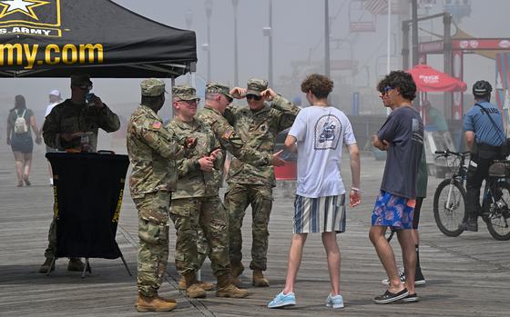 Beaston and his team talk with young men on the boardwalk in Seaside Heights. MUST CREDIT: Michael S. Williamson/The Washington Post