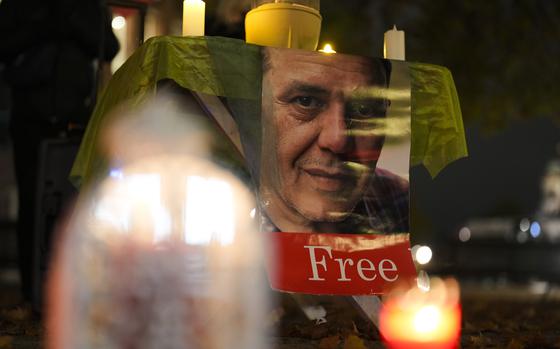 People commemorate Iranian-German Jamshid Sharmahd during a protest following his execution in Iran, near the Foreign Ministry in Berlin, Germany, Monday, Oct. 28, 2024. (AP Photo/Markus Schreiber)