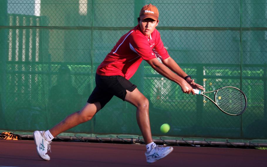 Nile C. Kinnick’s Aaden Otteson chases down a backhand groundstroke during Wednesday’s Kanto Plain tennis matches. Pho lost St. Mary’s Taiga Sherr-Oshima 8-1.