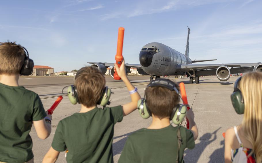 Children marshal an aircraft