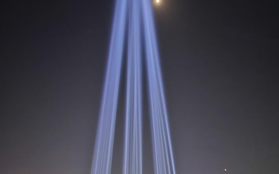 Fifty-five sailors and marines killed in combat are memorialized by lights beamed skyward at Daejeon National Cemetery, South Korea, March 21, 2024. 