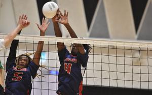 Aviano's Jules LaSalle gets his hand on a ball while blocking with teammate Deon Walker on Saturday, Nov. 2, 2024, in the championship game of the DODEA-Europe Boys Volleyball Championships in Vicenza, Italy.