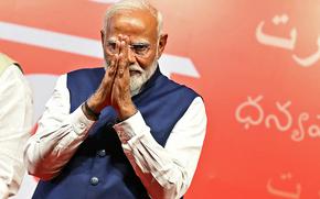 India’s Prime Minister Narendra Modi presses his hands together in a prayer gesture.