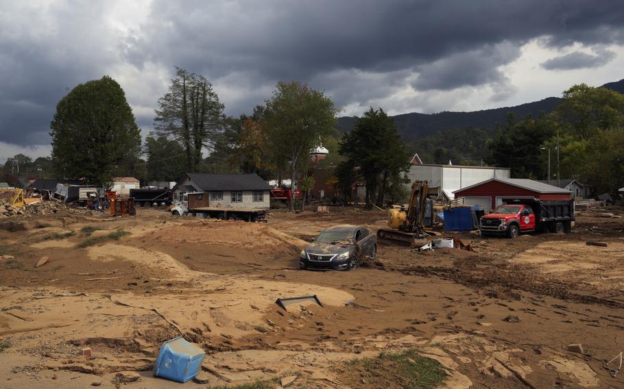 A car in Swannanoa sits amid debris, mud and clay left when Helene hit North Carolina. 