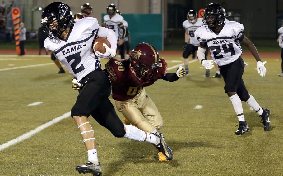 Zama's Keahnu Araki races around left end against Matthew C. Perry during Friday's DODEA-Japan football game. The Trojans won 50-0.