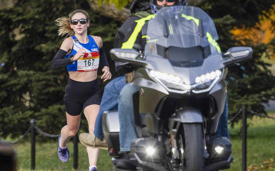 Tessa Barrett of Arlington, VA., follows a motorcycle escort 