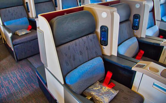 A row of airplane seats is seen inside a commercial airliner.