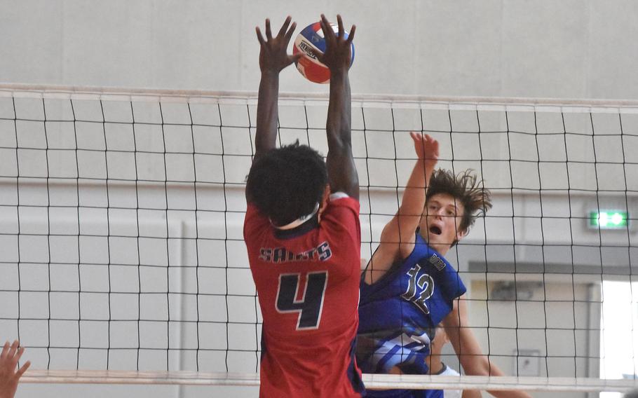 Aviano’s Jules La Salle is all over a spike from Rota’s Noah Snider during the Saints’ four-set victory over the Admirals on Saturday, Oct. 14, 2023.