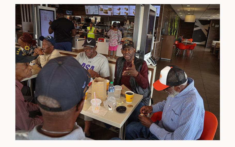 Marine veteran Roosevelt Randolph, center, gets in a deep discussion with fellow Black military veterans at a local McDonald’s on March 28, 2024, in Miami. The group gathers daily to share memories, stories and fellowship. 