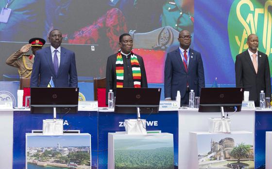 Kenyan President and East African Community (EAC) Chairman William Ruto, left, and Zimbabwe President and Southern African Development Community (SADC) Chairman Emmerson Mnangagwa, centre left, attend a joint summit to address conflict in Eastern Democratic Republic of Congo in Dar es Salaam, Tanzania Saturday, Feb. 8, 2025. (AP Photo/Elia Yunga)