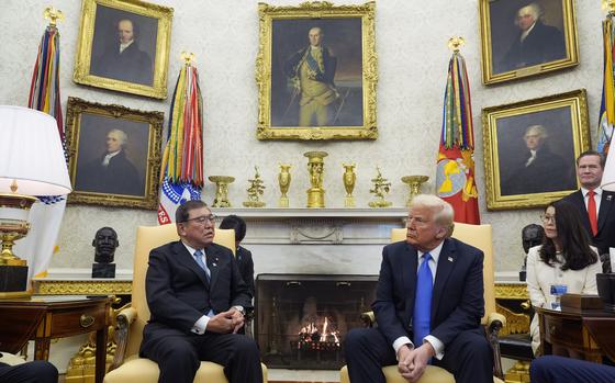 The prime minister of Japan, left, sits next to the president of the United States in the Oval Office.