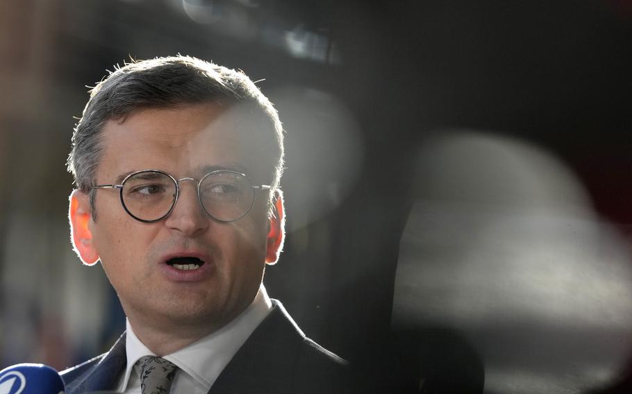 Ukraine’s Foreign Minister Dmytro Kuleba speaks with the media as he arrives for a meeting of EU foreign ministers at the European Council building in Brussels.