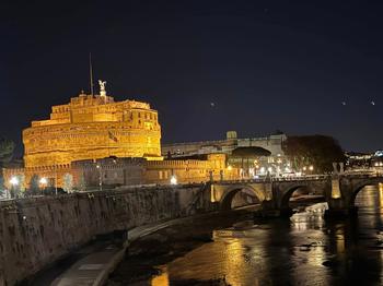 Exterior of Castel Sant’ Angelo lit up against a black night sky