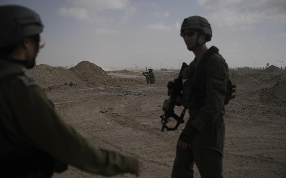 Israeli soldiers take up positions next to the Philadelphi Corridor in Gaza along the border with Egypt.