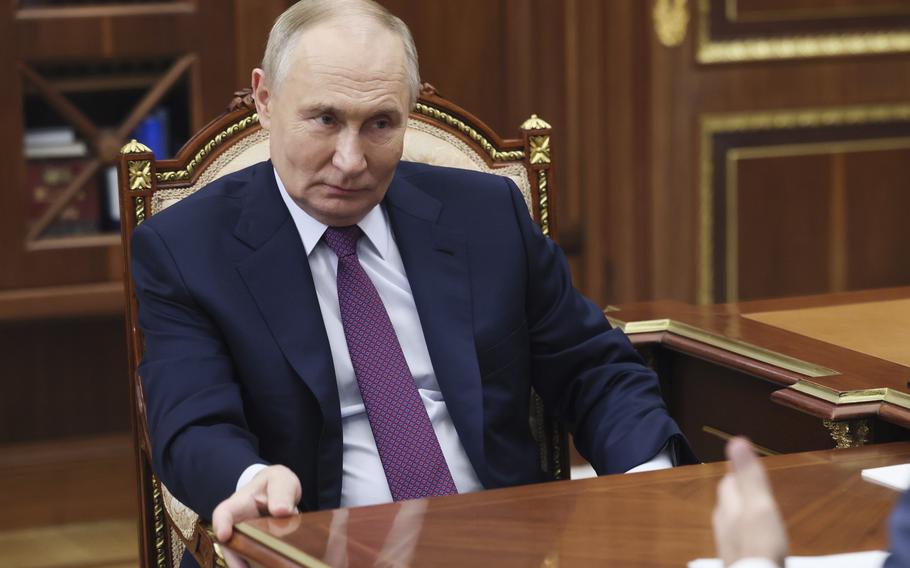 Russian President Vladimir Putin attends a meeting 