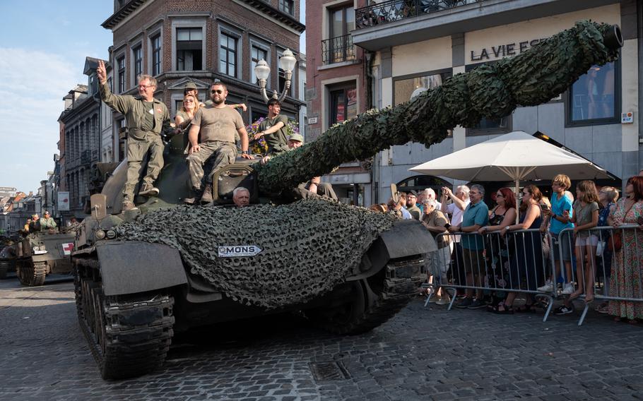 Spectators watch vintage military vehicles parade through Mons, Belgium, on Sunday, Sept. 1, 2024. The annual Tanks in Town event it held to honor the U.S. soldiers who liberated the city during World War II. 