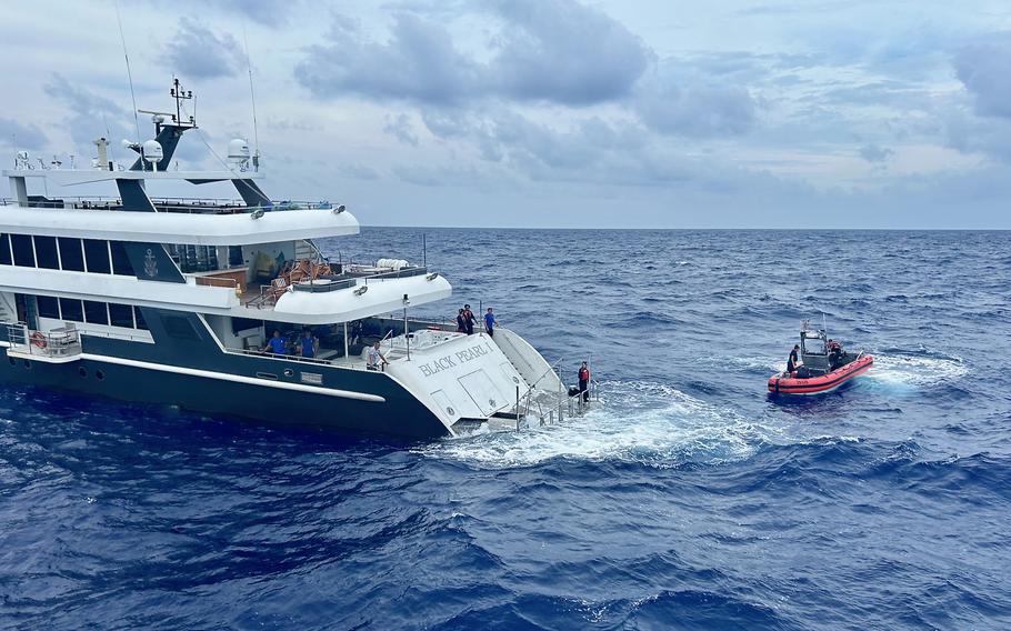 A rescue team from the U.S. Coast Guard cutter Oliver Henry approaches the luxury yacht Black Pearl 1 about 230 miles west of Palau, July 21, 2024.