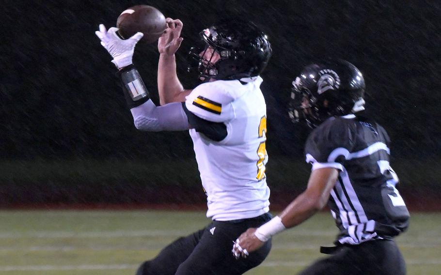 American School In Japan's Andreas Elstrom catches a pass in front of Zama's Chayden Williams.