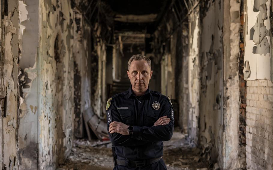 Serhii Bolvinov stands in the destroyed Kharkiv police building