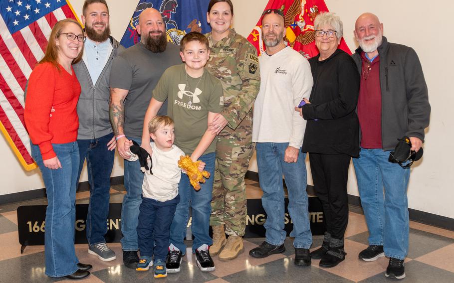 Soldier and his family pose for a photo