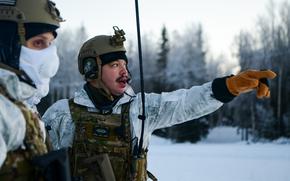 U.S. Air Force Tech. Sgt. Richard Padilla, a security forces craftsman assigned to the 24th Special Operations Wing, Detachment 1, also known as Deployment Cell or “D-Cell”, directs Airmen during a training exercise at Joint Base Elmendorf-Richardson, Alaska, Jan. 7, 2023. Based out of MacDill Air Force Base, Florida, D-Cell consists of 54 members across 15 job codes forming four agile teams, whose primary role is to “bare base” – to rapidly turn undeveloped locations into fully functional bases. The unit visited Alaska to train and test their capabilities in an arctic environment. (U.S. Air Force photo by Senior Airman Patrick Sullivan)