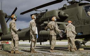 Soldiers with the 12th Combat Aviation Brigade load rockets into an Apache helicopter at Grafenwoehr Training Area on Sept. 24, 2024. 