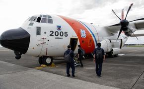 Members from the Japanese Fisheries Agency and Korea coast guard board a U.S. Coast Guard HC-130J Super Hercules at Yokota Air Base, Japan, Sept. 22, 2023.