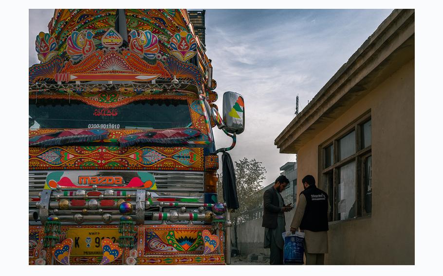 A truck hauling apples about to be exported to Pakistan is weighed to calculate taxes, at the Kabul customs office located in the eastern outskirts of the Afghan capital.