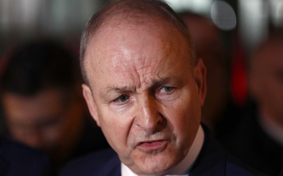 Fianna Fail leader Micheal Martin talks to the media outside the government building in Dublin, Wednesday, Jan. 22, 2025.